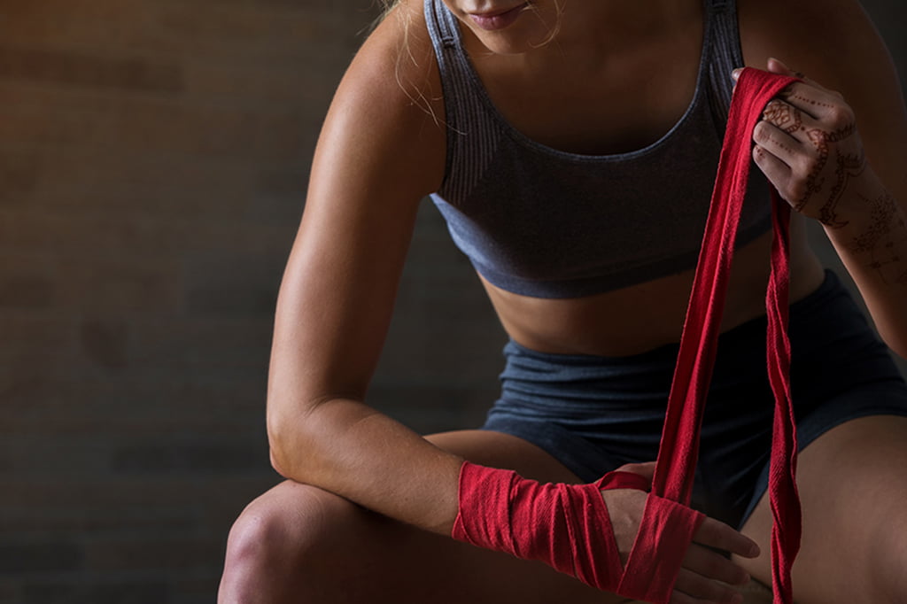 women tying wrist wraps