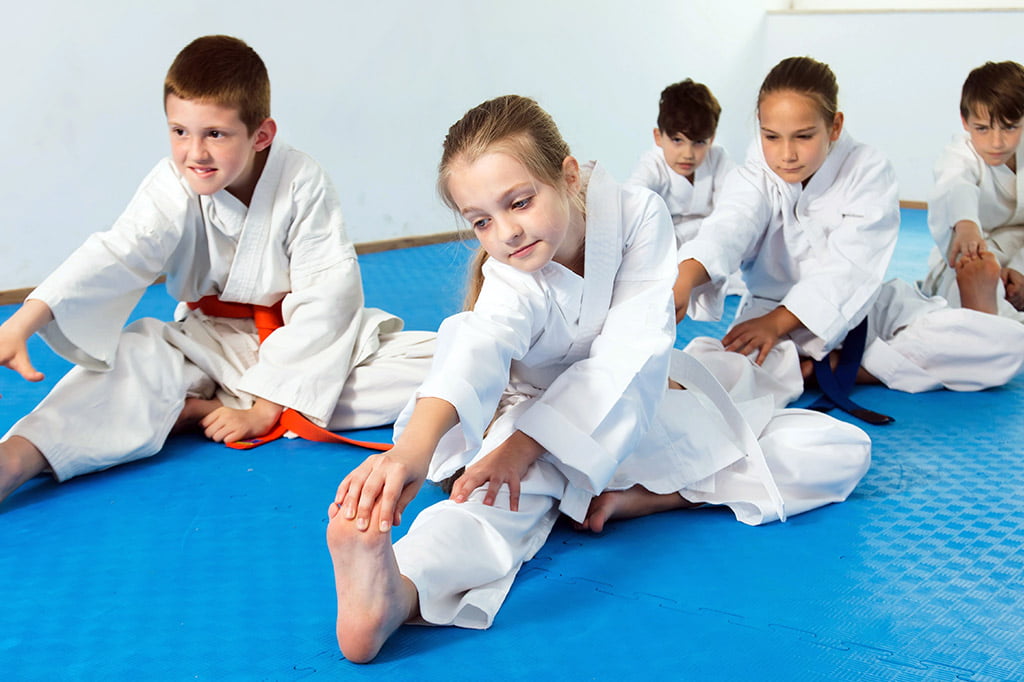 Bernardo Karate students doing warm up stretches