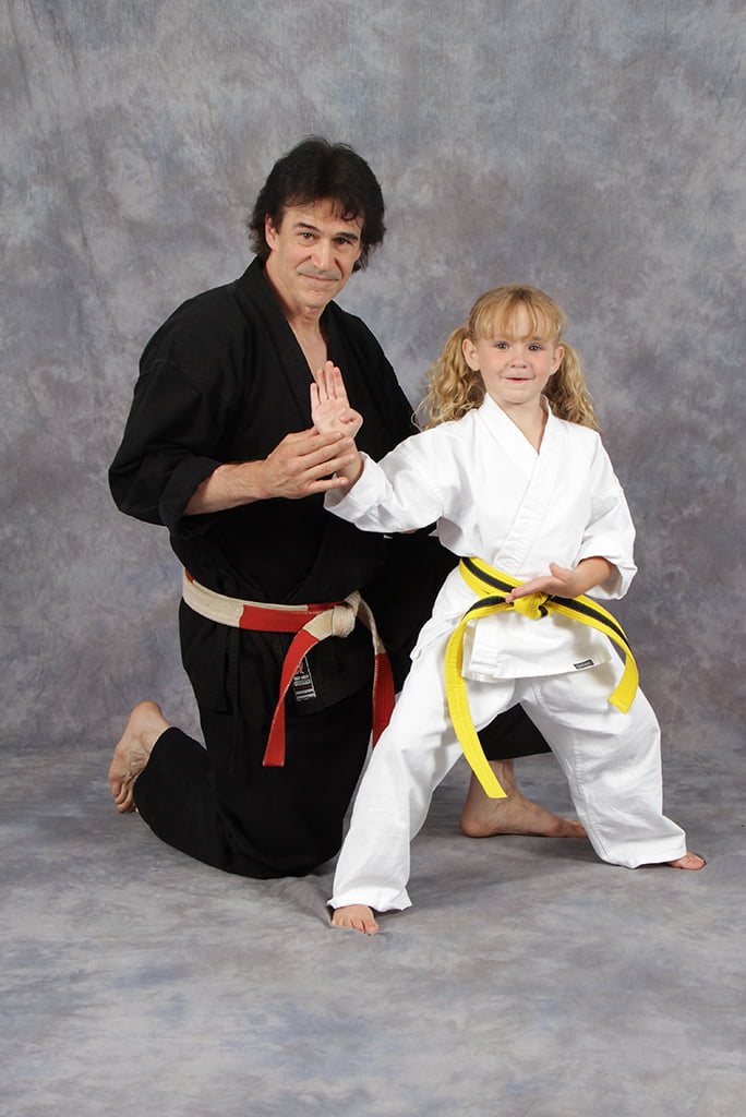 Michael Bernardo posing with young student