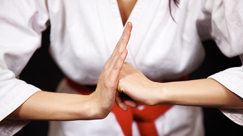 women hitting fist into palm