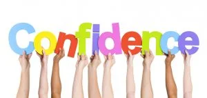 kids hands holding up letters to spell confidence